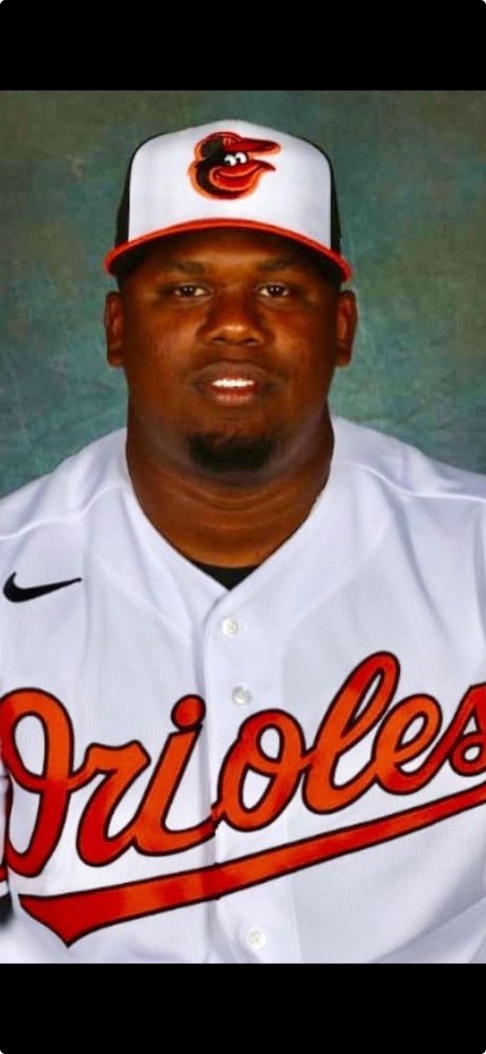 Coach Deiby Ramírez in an Orioles baseball uniform